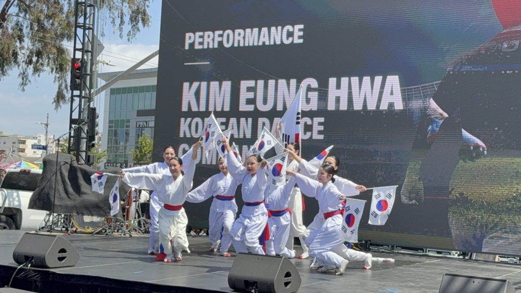 Kim Eung Hwa Korean Dance Company posing in front of the performance stage