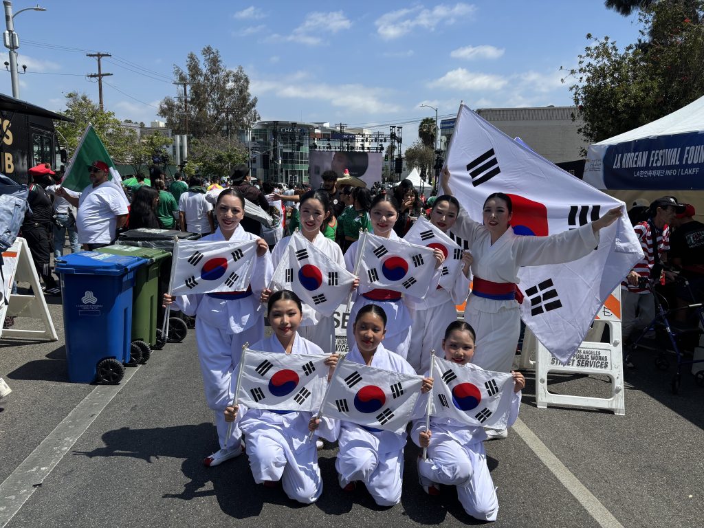 Kim Eung Hwa Korean Dance Company cheering with the crowd in Koreatown